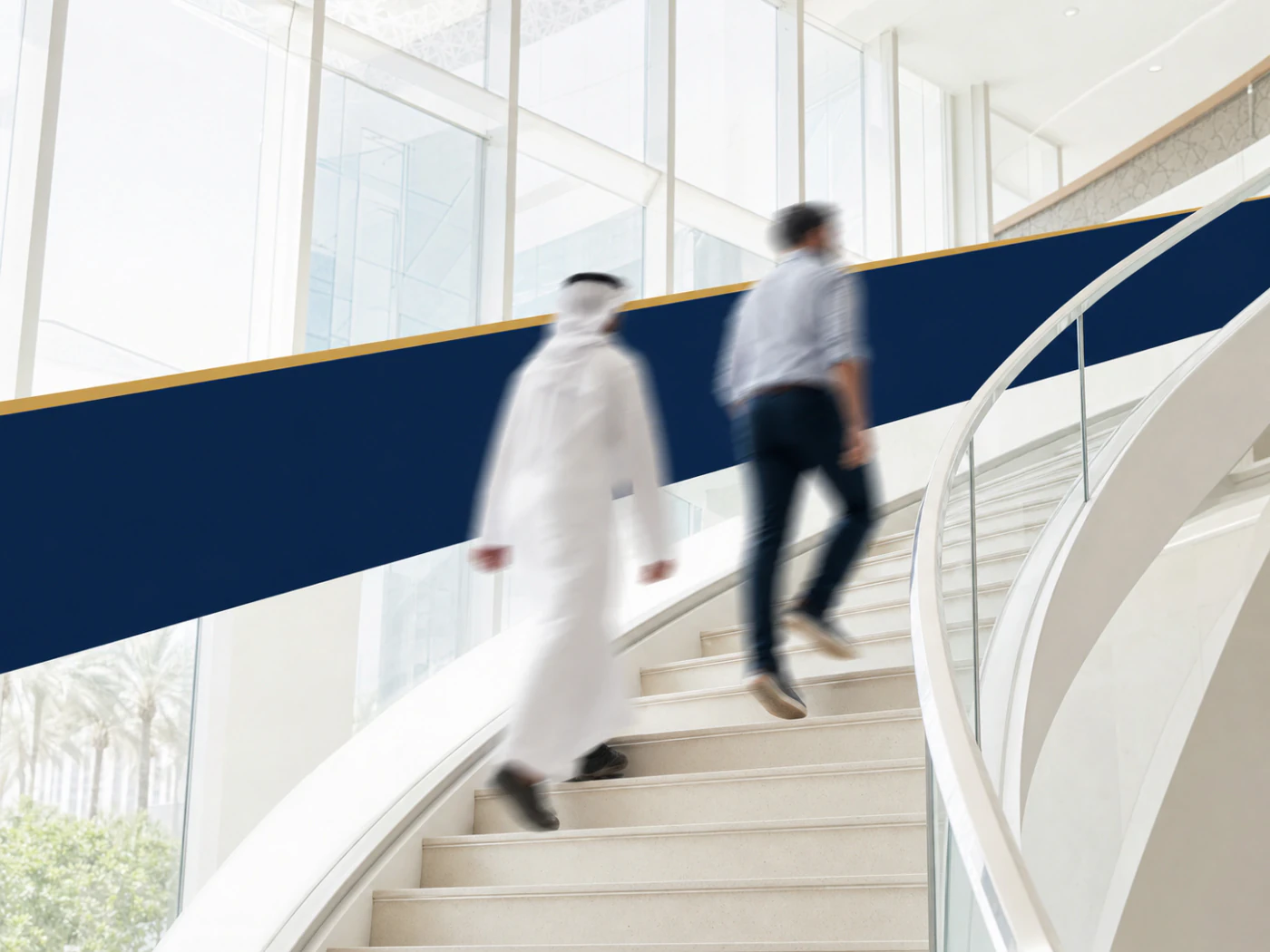 Two motion-blurred professionals ascending a bright sculptural staircase.